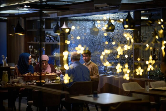 People enjoying a meal at a warmly lit local restaurant in Istanbul