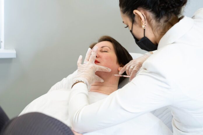 botox-fillers-istanbul-aesthetic-clinic Woman receiving a facial injection procedure at an aesthetic clinic in Istanbul