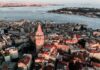 Your 12-Item To-Do List for Unforgettable Istanbul Experiences Aerial view of the Galata Tower surrounded by buildings and the Bosphorus in Istanbul