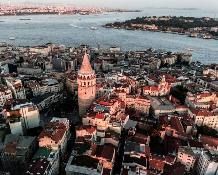 Aerial view of the Galata Tower surrounded by buildings and the Bosphorus in Istanbul