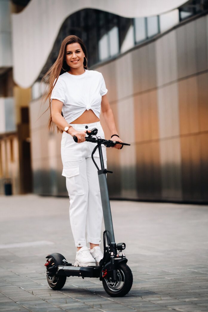 istanbul-e-scooter-shared-mobility Young woman riding an electric scooter in a city street