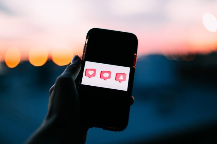 Smartphone screen showing social media notifications and Instagram-style content