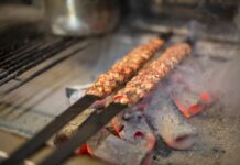 Istanbul Kebab Guide: Çağ, Urfa, Adana, and Where to Eat Each One Meat skewers grilling over hot charcoal at a Turkish kebab restaurant