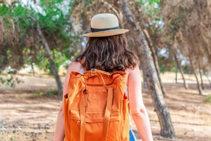 Backpacker traveler with a backpack exploring on a budget