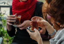 Turkish Culture Guide: Customs, Etiquette, and What to Expect Two women sharing Turkish tea in traditional tulip-shaped armudu glasses