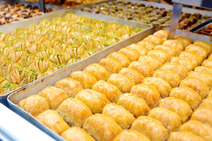 turkish-desserts-guide-baklava Assortment of traditional Turkish desserts including baklava and other sweet pastries