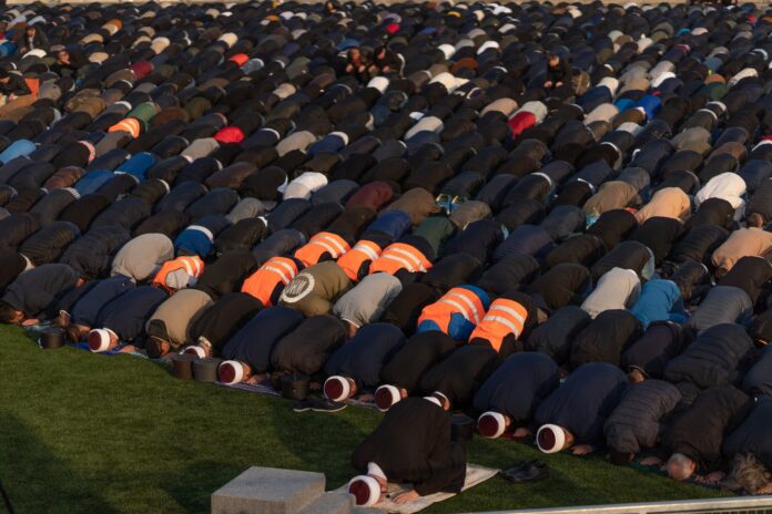 Large gathering of worshippers praying outdoors during Bayram in Istanbul