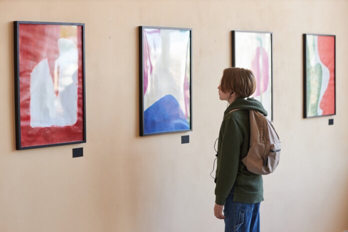 best-art-exhibitions-istanbul-1 Visitor looking at abstract art on a gallery wall