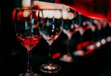 8 Best Wine Bars in Istanbul: Turkish Wines Worth Trying Wine glasses being poured at a stylish wine bar