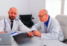 How to Vet a Plastic Surgeon in Istanbul Before Booking Two doctors in white coats reviewing a patient X-ray at a clinic desk
