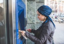 Istanbul ATMs Guide: Fees, Limits, and Which Banks Are Foreign-Friendly Person using a bank ATM in Istanbul