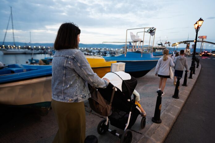 stroller-friendly-istanbul-routes-1 Mother with baby carriage on a waterfront pier in the evening