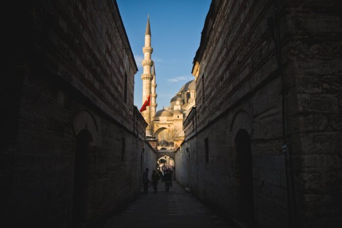 sultanahmet-hidden-corners-side-streets Narrow historic alley in Sultanahmet, Istanbul, with mosque minarets in view