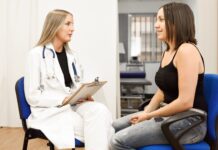 Medical Tourism Insurance in Turkey 2026: Istanbul Guide Doctor with a clipboard speaking with a patient in a consultation room
